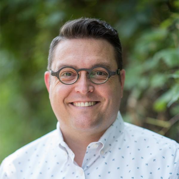 Smiling portrait of Jeremiah Cawley wearing glasses